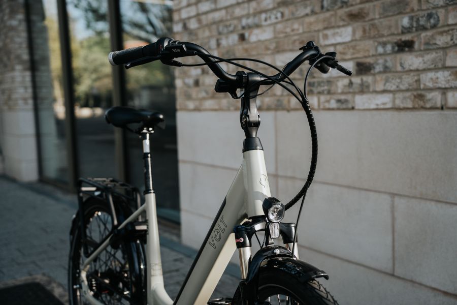 Front angle of VOLT Regent electric bike with suspension forks and integrated lights, available in Edinburgh at Leith Cycle Co